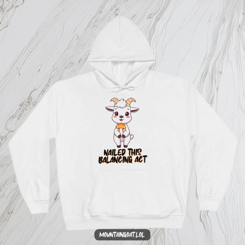 Funny mountain goat hoodie, a cheerful goat balancing a delicate mushroom on its nose, designed for cozy outdoor fun.