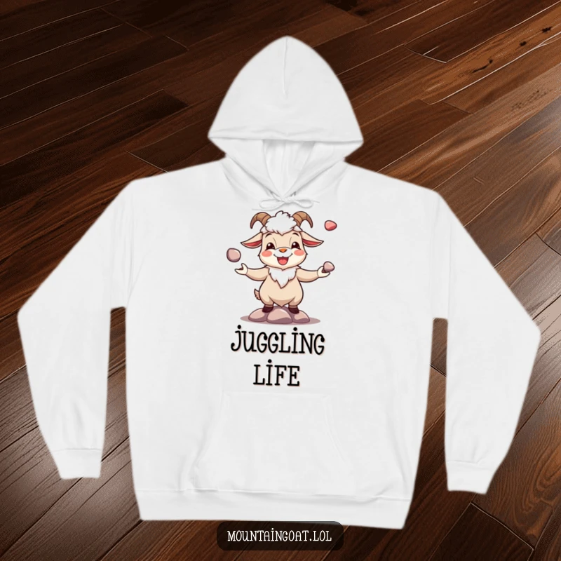 Funny joyous mountain goat juggling shiny pebbles, featured on a warm, comfortable hoodie. Cheerful and snug.