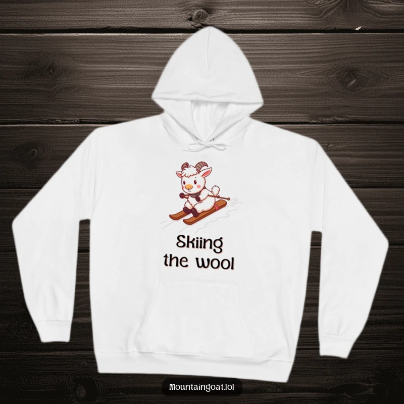Funny playful mountain goat sliding down a yarn ski slope, featured on a warm and comfortable hoodie. Whimsical and snug.
