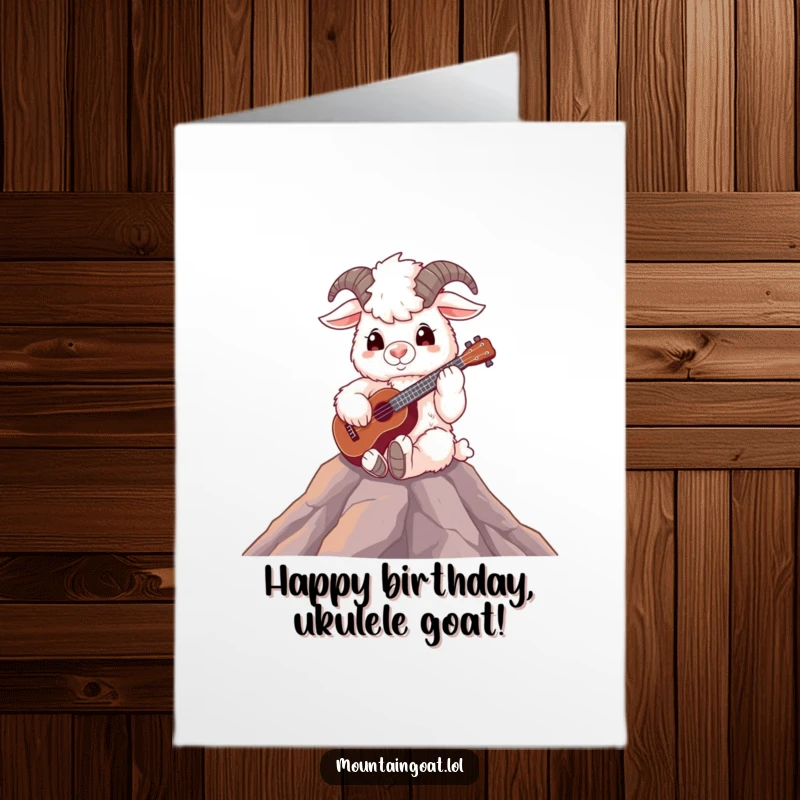 Funny free printable birthday card featuring a fluffy mountain goat sitting on a peak, happily playing a ukulele.