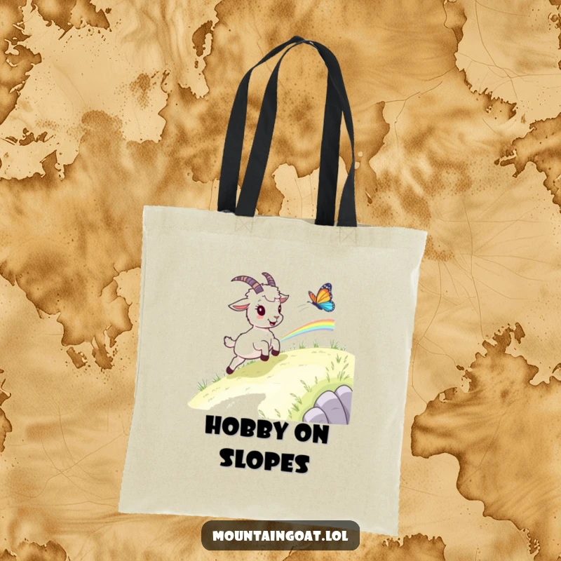 Funny goat butterfly tote bag, a mountain goat excitedly chasing a rainbow butterfly across a beautiful grassy landscape.
